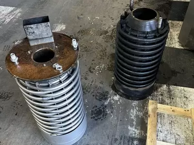 Comparison of failed and new boiler coil from industrial hot pressure washer during emergency repair in Atherstone.